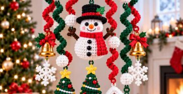 Crocheted Christmas mobile with snowman, Christmas trees, house, snowflakes, bells, and spiral garlands hanging from a wooden ring.