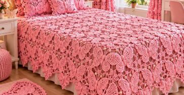 A beautifully decorated bedroom featuring a pink crochet butterfly bedspread, matching pillows, curtains, and a butterfly-shaped rug.