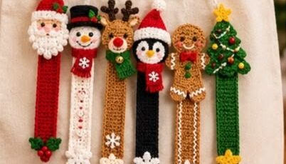Six colorful crocheted Christmas character bookmarks, including Santa, snowman, reindeer, penguin, gingerbread, and a tree, displayed on a tote bag.