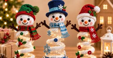 Three crocheted spiral snowmen with festive hats, scarves, and decorated bases, each with a lighted spiral body, set against a holiday background.