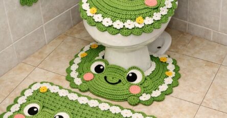 Crochet bathroom set with frog faces, lily pads, flowers, and a frog-shaped toilet paper holder.