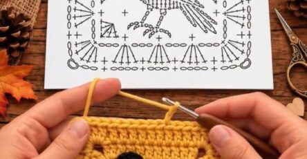 A crochet granny square with a black crow appliqué on a mustard yellow background next to a printed crochet stitch diagram.