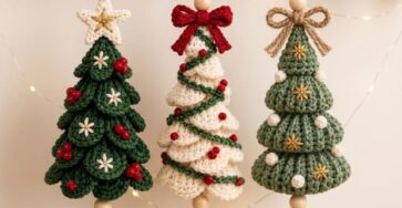 Three handmade crochet Christmas tree ornaments with layered branches, beads, bows, and bells in green and cream colors.