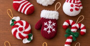 A set of handmade crochet Christmas ornaments including Santa, stockings, a mitten, a candy, snowman, boot, bauble, candy cane, and a star.