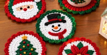 A set of crocheted Christmas coasters featuring Santa, a snowman, a Christmas tree, and a poinsettia, displayed on a wooden table.