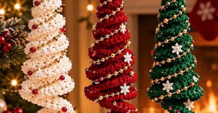 Three spiral crochet Christmas tree ornaments in white, red, and green with gold bead garlands, star toppers, and hanging snowflake charms.