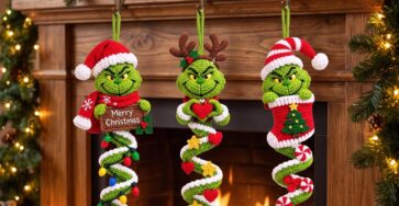 Three crocheted Grinch Christmas spiral decorations with festive themes hanging on a fireplace mantel, surrounded by Christmas lights and candles.