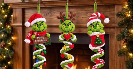 Three crocheted Grinch Christmas spiral decorations with festive themes hanging on a fireplace mantel, surrounded by Christmas lights and candles.