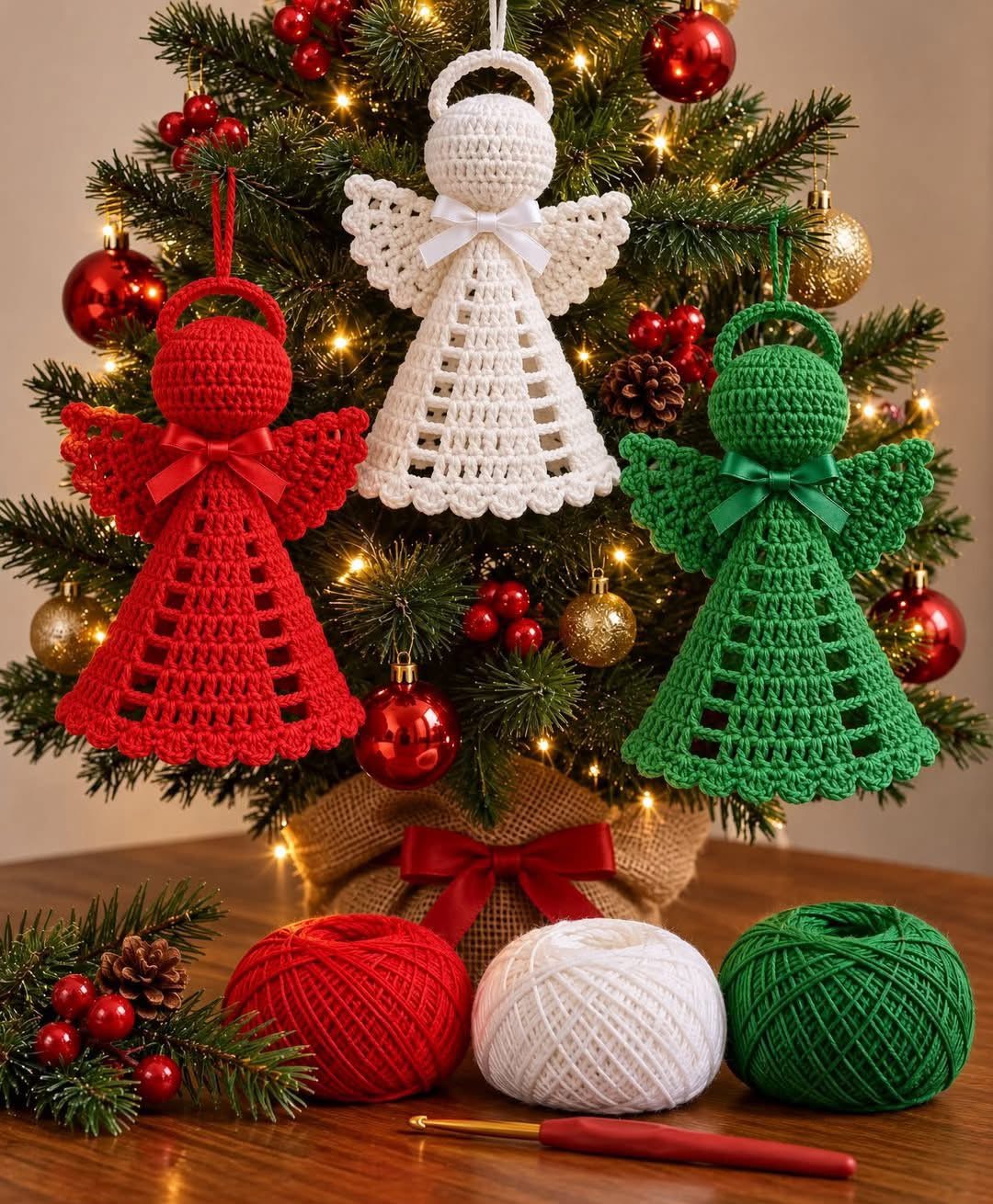 Three crochet angel ornaments in red, white, and green with lacy dresses and wings, displayed on a Christmas tree.