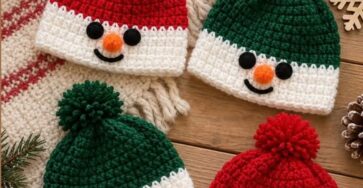 Crocheted snowman beanie hats with red and green tops, white lower sections, pom poms, and smiling snowman faces.