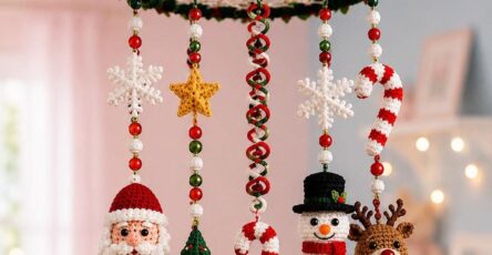 A colorful crochet Christmas mobile with Santa, snowman, reindeer, Christmas tree, candy canes, snowflakes, and stars hanging from a decorated circular frame.