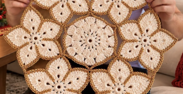 A hand-crocheted centerpiece made of cream and gold floral motifs joined into a round decorative mat.