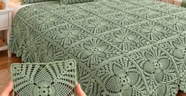 Light sage green crocheted bedspread with matching pillows, featuring intricate lacy square motifs in a bright and elegant bedroom.