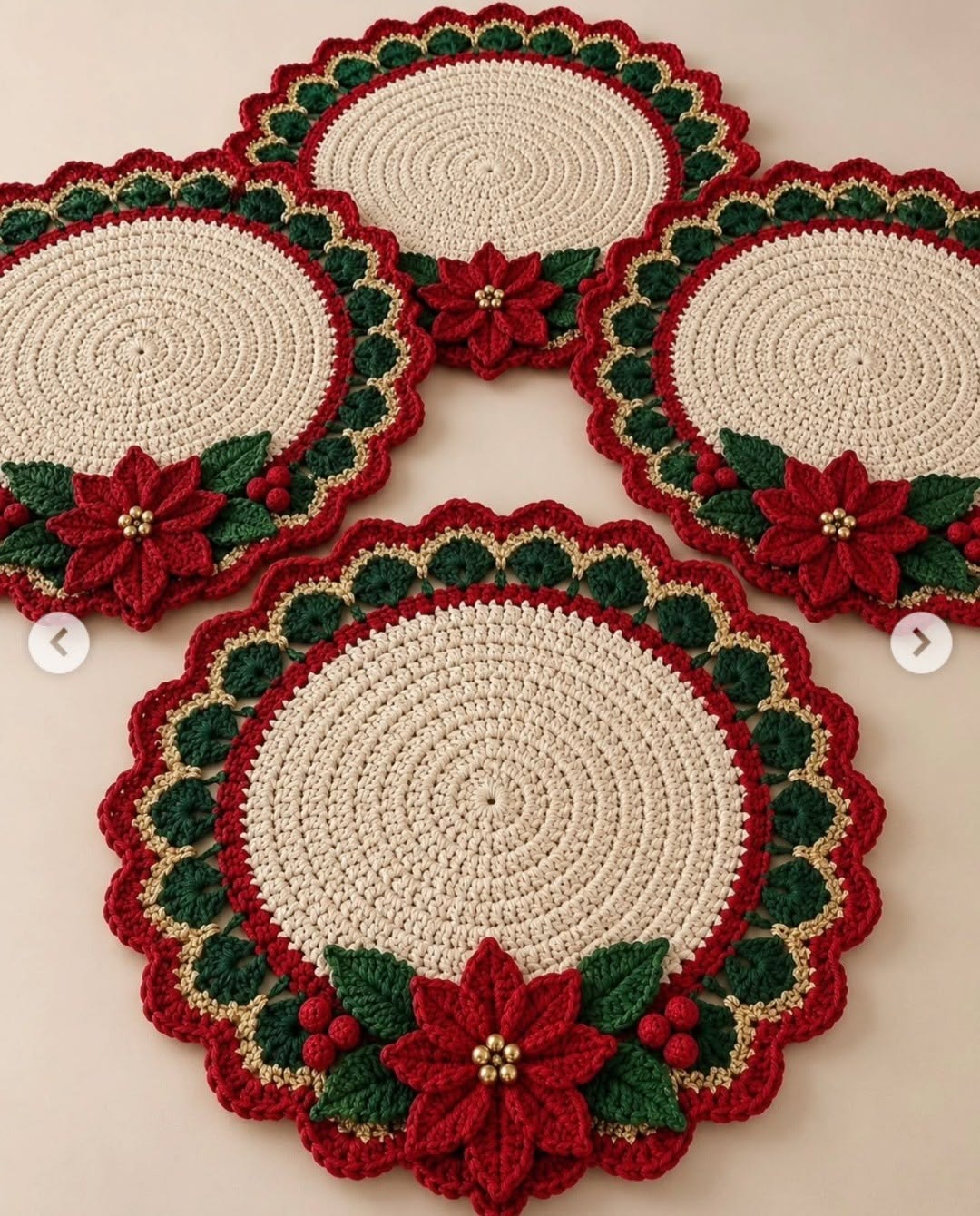 Round crochet placemat with cream center, scalloped red, green, and gold border, and a red poinsettia floral applique with green leaves.